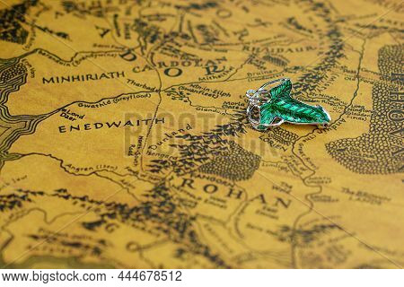 Astrakhan, Russia - 01.03.2022: Elven Lorien Brooch Lies On Middle-earth Map