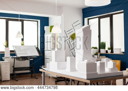 Table With White Architectural Scale Foam Model Of Building Complex In Empty Modern Architect Office