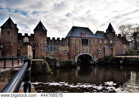 Wide Angle View On The Historical Brick Stone Koppelpoort With Water And Sky In The Center Of Amersf