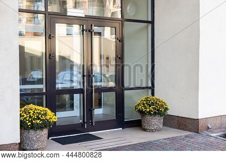 The Front Door Of A Office Block, Reflecting Buildings In The Glass