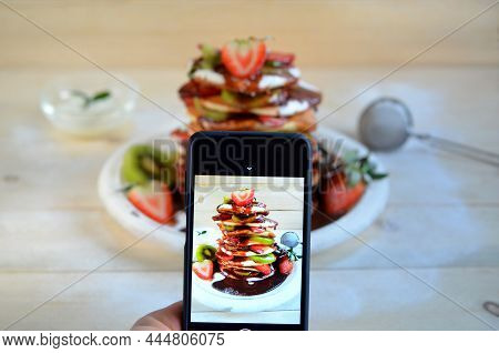 Person Creating Content For Social Media Takes Pictures For A Blog About Food Using His Phone