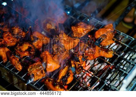 Delicious Grilled Tandoori Of Assorted Meats Over Charcoal And Hot Grill On Skewers.