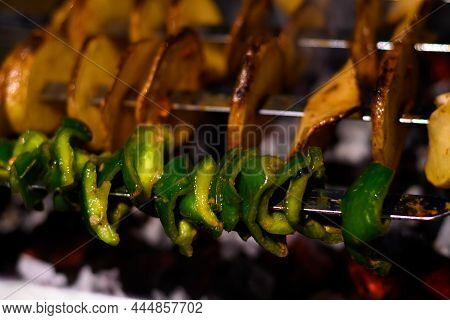 Delicious Vegetarian Skewers Made From Potatoes And Capsicum Over The Coals On A Barbecue.