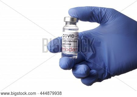 Krasnoyarsk, Russia. April 29, 2021. Doctor Hand Holds Moderna Covid-19 Vaccine. Blue Gloved Hand Wi