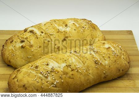 Wheat Bread Baked From Flour At Home. Tasty Bread On Wooden Board  Against Background. Food With No