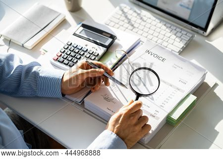 Fraud Investigation And Tax Audit. Investigator Or Auditor Using Magnifying Glass