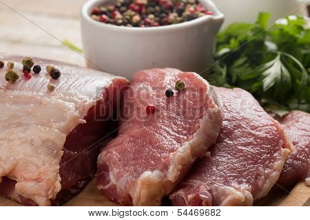 Fresh Raw Meat On Wooden Background With Pepper