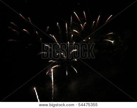 Fireworks exploding high in the night sky.