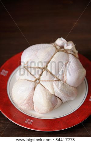 Bondage Shibari Raw Chicken On Red Boarder Plate On Dark Wood Background