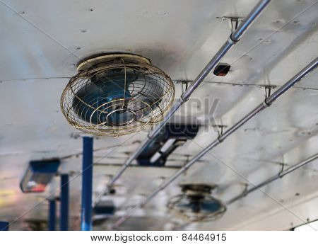 Old Ceiling Fan  Blurred Slightly As Blades Turn On The Bus