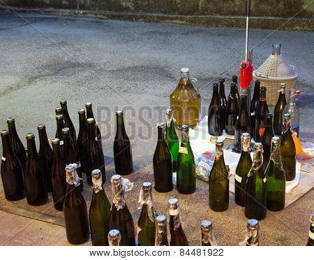 Pour The Wine In The Backyard With The Carboy And Bottles