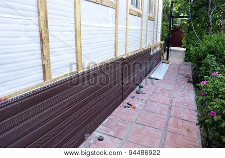 Installation Of Brown Plastic Siding On The Facade