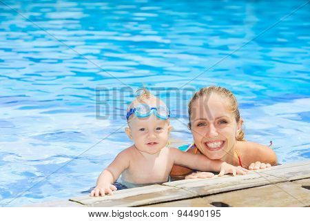 Funny Portrait Of Baby Boy Swimming With Mother In Pool