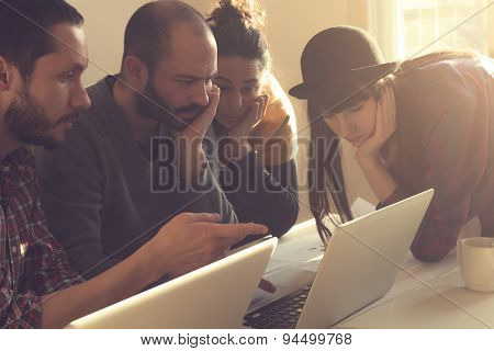 Young group of people/architects discussing business plans.