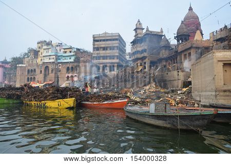 View of Varanasi city and cremation pyres from river Ganga, Varanasi, Uttar Pradesh, India
