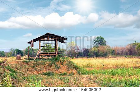 Vintage wooden cottage in the farm with beautiful sunlight and cloudsky.
