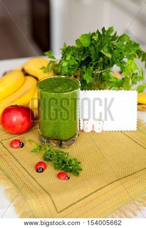 Vitamin smoothie in glass linen napkin on the kitchen table. Healthy eating. Cleansing oragizma. Detox