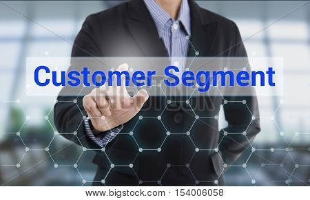 Businessman hand pressing button customer segment. sign on virtual screen. business concept.