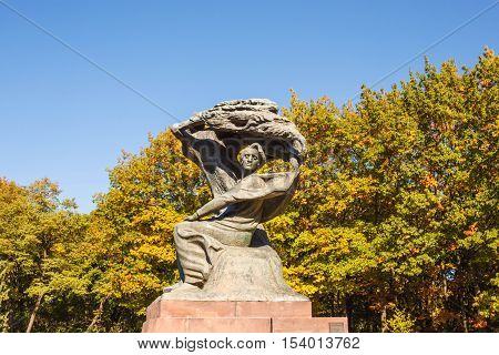 Warsaw Poland - October 10 2015: Frederic Chopin monument in Lazienki park (Royal Baths park). Designed in 1907 by Waclaw Szymanowski.