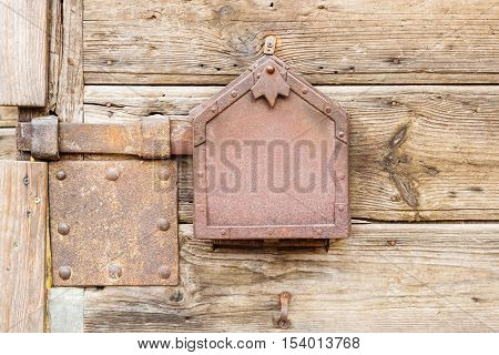 Old wooden doors locked with rusty metal latch