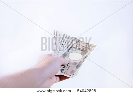 Men's hand holds 10000 Japanese Yen Bank Note
