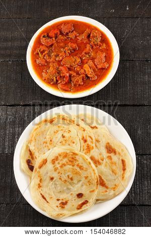 Overhead view-Spicy and tasty Asian flat bread paratha with meat curry