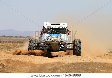 Front View Close-up Of White Bat Rally Car At Road Crossing