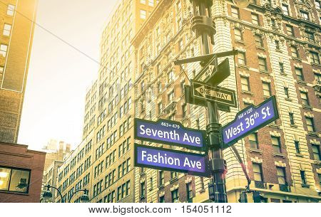 Street sign of Seventh and Fashion Ave with West 36th St at sunset in New York City - Urban concept and road direction in Manhattan - American world famous capital destination on warm vintage filter