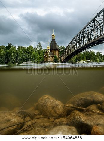Karelia.Russia.15 Aug 2016 .View of the Church of St. Andrew on the island on the lake Vuoksa in Karelia the view over the water and under water