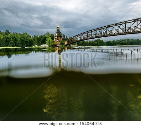 Karelia.Russia.15 Aug 2016 .View of the Church of St. Andrew on the island on the lake Vuoksa in Karelia the view over the water and under water
