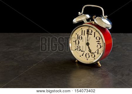 old fashioned alarm clock shows 5am which means its time to get out of bed to start your day