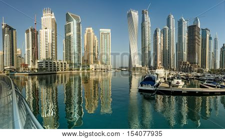 DUBAI, UAE - OCTOBER 09, 2016: Dubai Marina is a man made marina stretching over 3km of land. Surrounded by tall unique skyscrapers with apartments and restaurants, the marina is open to The Gulf.