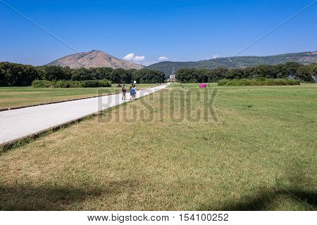 Caserta Italy - August 29 2016: Tourists visit the park of Caserta Royal Palace a former royal residence in Caserta constructed for the Bourbon kings of Naples