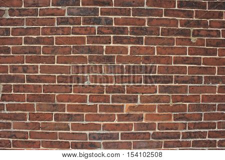 Red brick weather stained wall textured background