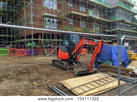 Bracknell,England - October 30, 2016: An apartment block surrounded by scaffolding and construction equipment on a building site in Bracknell, England. The industry is expected to grow over 2% in 2017