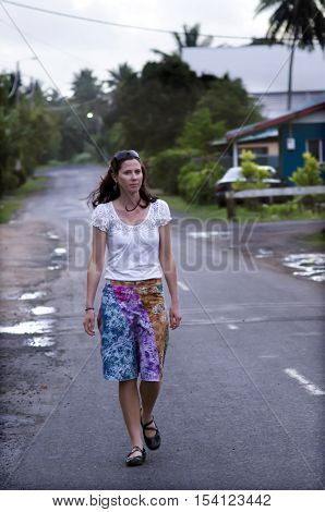 Young Woman Travels In Tropical Town.