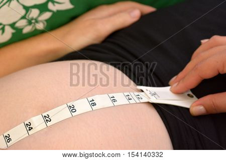 CABLE BAY - APR 02 2014:Midwife checking measuring a pregnant mothers belly.Midwifery is a health care profession in which providers offer care to women during pregnancylabor birth and postpartum.