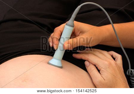 Midwife checks baby heart beat and movement.Concept photo of childbirth pregnancy postpartum period midwifery and pregnant woman lifestyle.