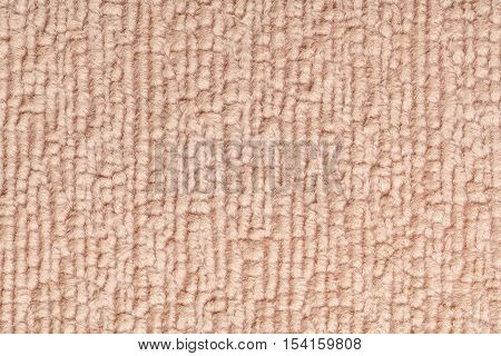 Light brown fluffy background of soft fleecy cloth. Texture of textile closeup