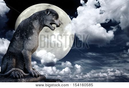 Ancient lion statue and bright moon in the night sky. Elements of this image furnished by NASA