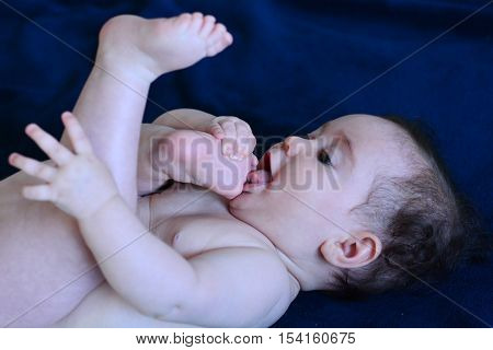 Baby Lying On Her Back Sucks Toe