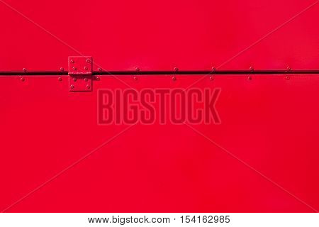 Red Painted Metal Background With Rivets And A Hinge