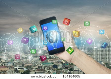 hand holding smartphone and concept technology social media network connection in city scape.