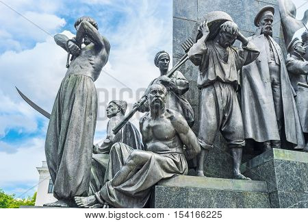 KHARKOV UKRAINE - MAY 20 2016: The statues of Ukrainian peasants -serfs around the monument to the famous poet writer and freedom fighter - Taras Shevchenko who was the serf by himself  on May 20 in Kharkov.