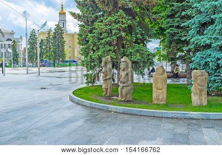 KHARKOV UKRAINE - MAY 20 2016: The stone idols of the ancient Slavs and Scythians decorate the flowerbed and attract people to visit State Historical Museum on May 20 in Kharkov.