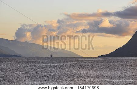 Norwegian fjord sunset landscape with cruise. Tourism Norway. Travel background