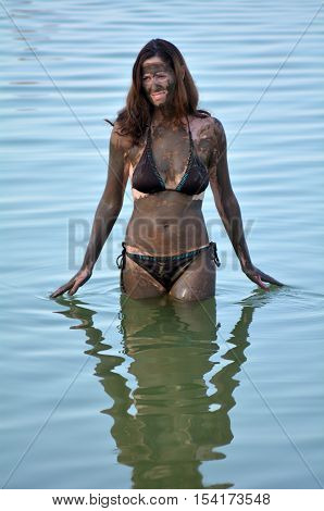 Woman Enjoying The Natural Mineral Mud Sourced From The Dead Sea Israel