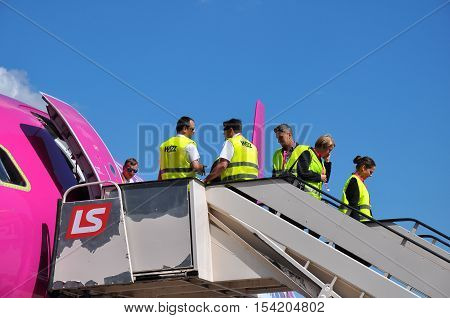 KATOWICE - JULY 2: Cabin crew staff leaving the Wizzair Airbus A320 after the landing on July 2 2015 in Katowice Airport Poland. Wizzair is one of the largest low-cost airlines.