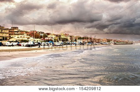 Beautiful landscape of the coast with dramatic sky and choppy sea. Falconara Italy.