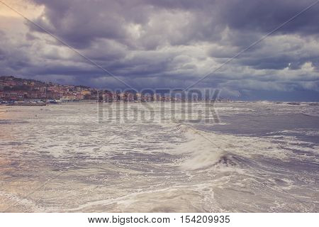 Beautiful landscape of the coast with dramatic sky and uncalm sea. Falconara Italy.